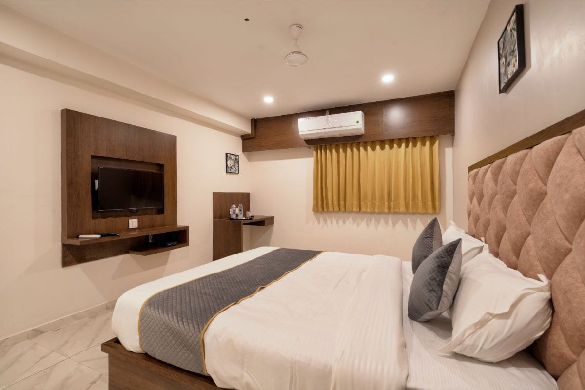 Deluxe Room with a wooden television panel and study desk