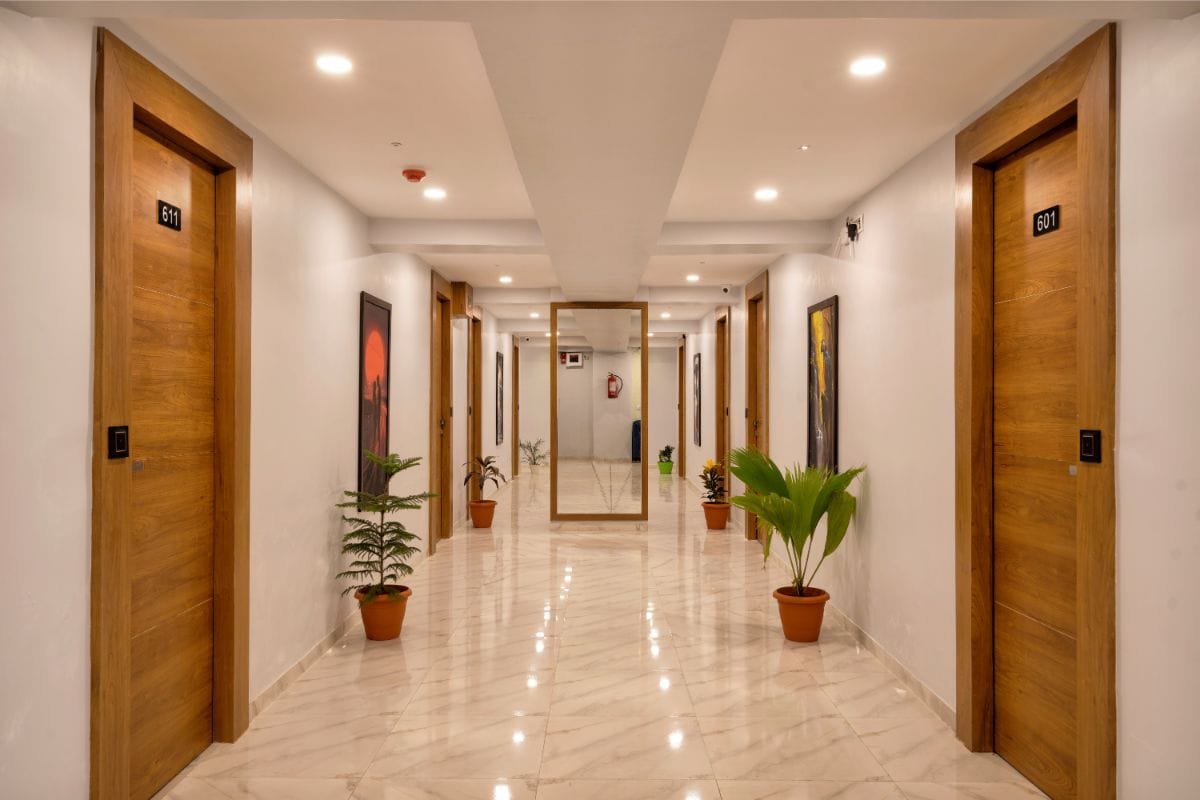 Long guest room corridor with polished marble flooring