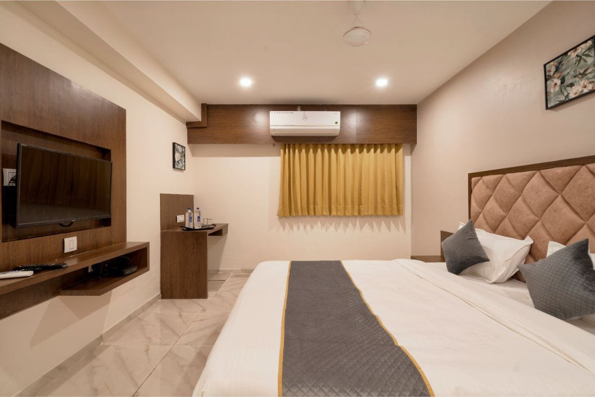 Deluxe Room with a large bed and warm lighting