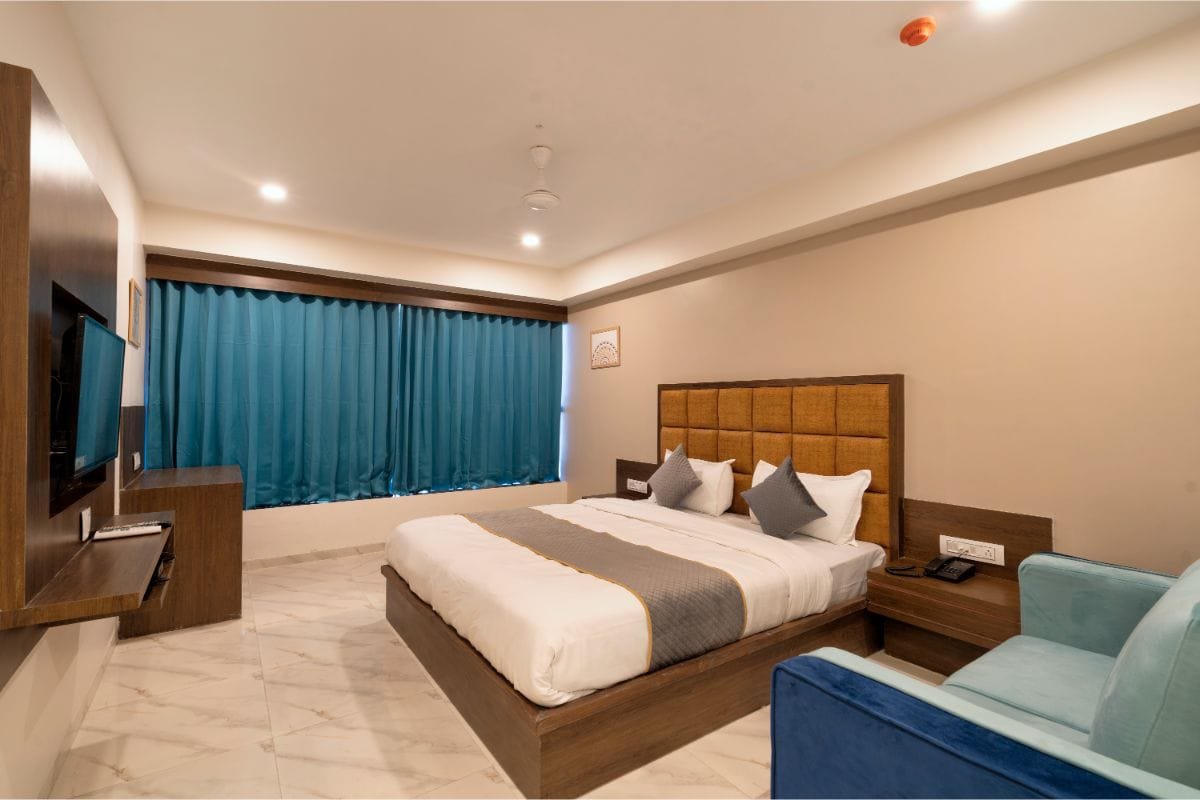 Super Deluxe Room at Hotel Royal 24 with a large bed and television unit