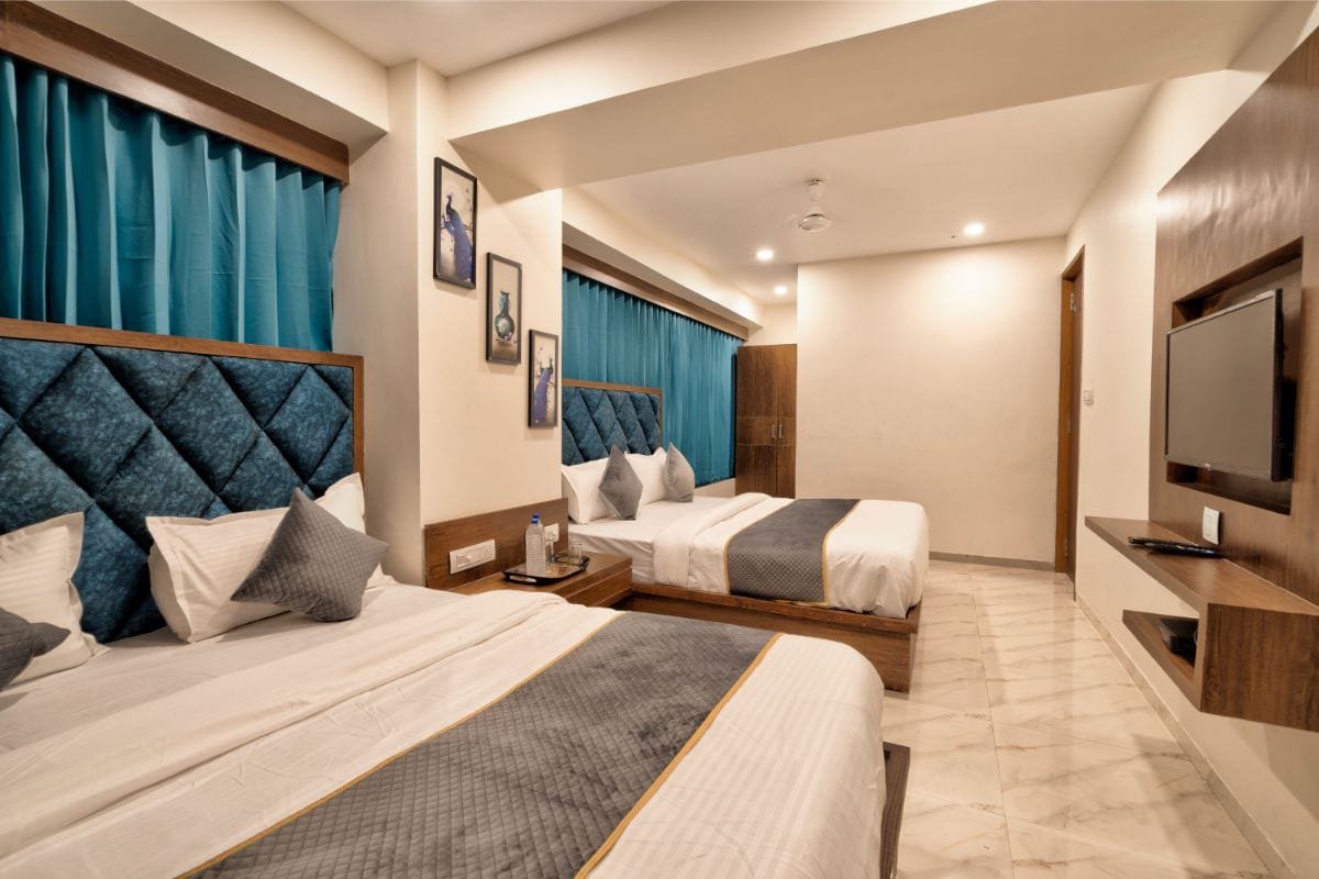 Family Room at Hotel Royal 24 with two large beds and elegant headboards